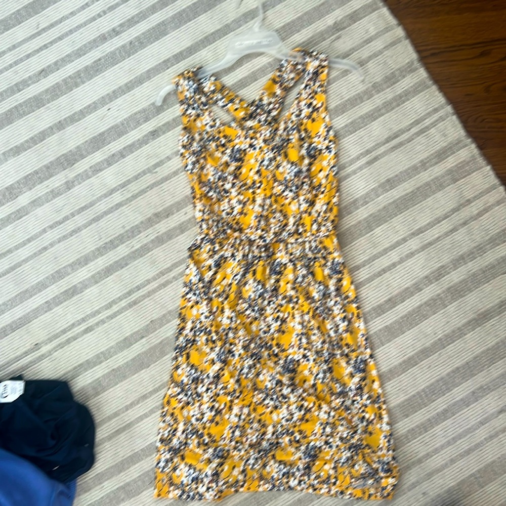 Yellow/floral dress w/ blue & white flowers. Criss cross back and elastic waist.